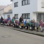 Gruppe von Kindern und Erwachsenen mit Laternen auf der Straße im Marktplatz Altomünster.